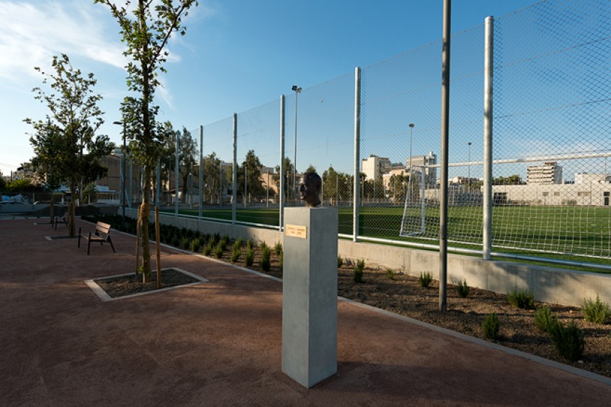 Φωτογραφία που δείχνει παγκάκια και δέντρα να περιβάλουν ένα γήπεδο ποδοσφαίρου