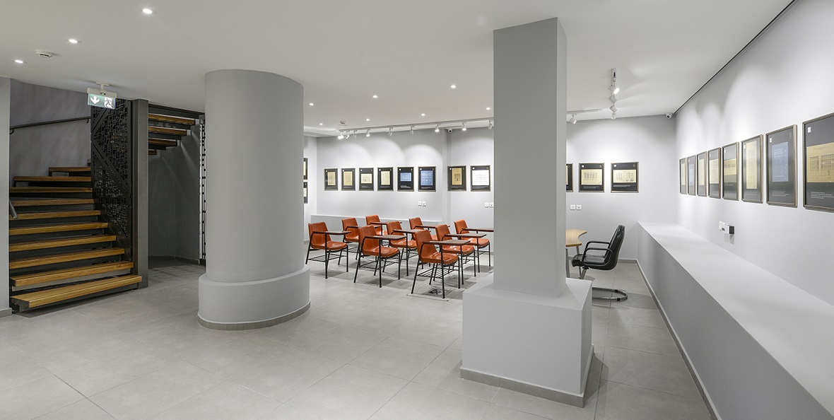 Μια αίθουσα της νέας πτέρυγας του Εβραϊκού Μουσείου Θεσσαλονίκης, η οποία περιλαμβάνει πολλές καρέκλες με γραφειάκια