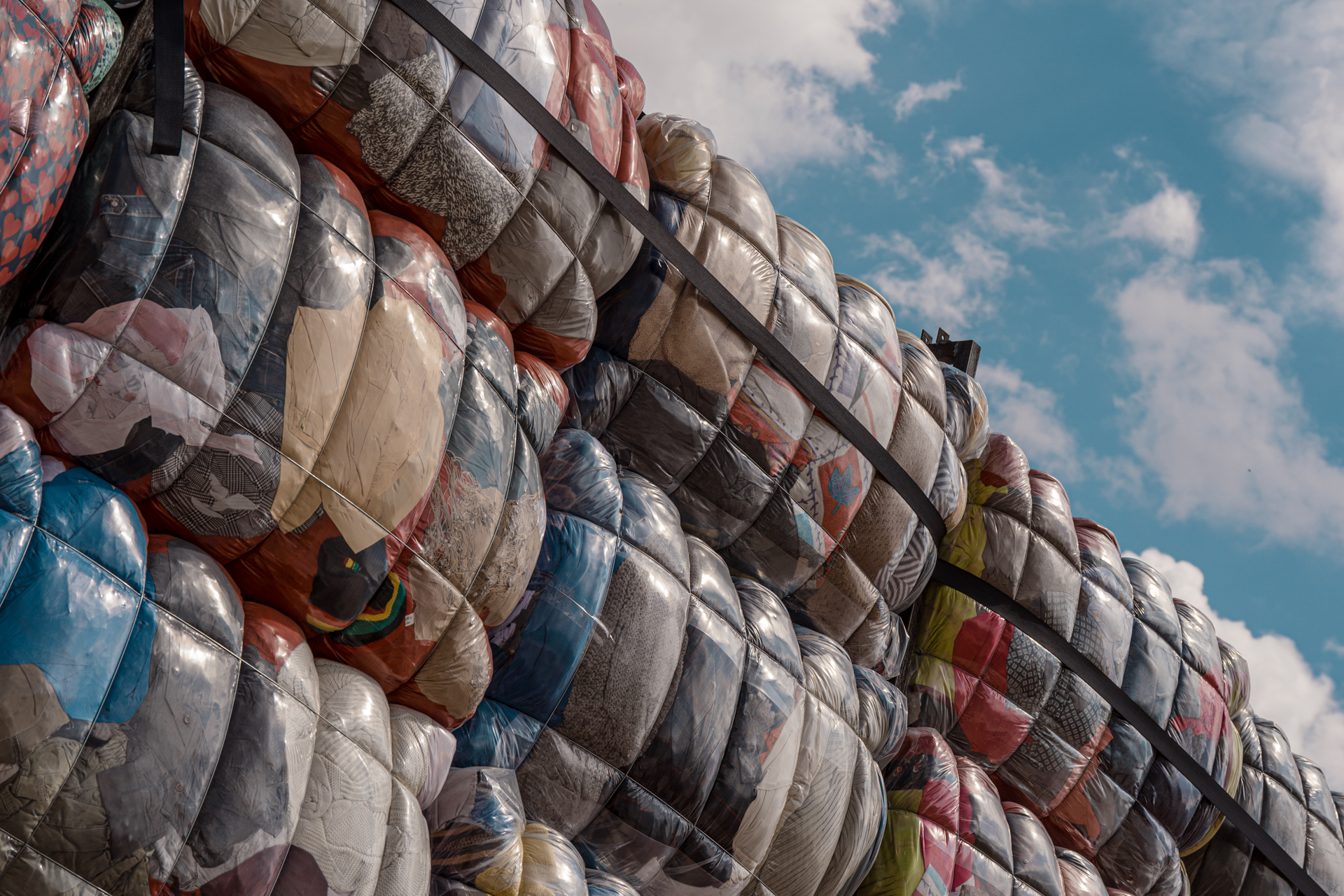A very close image of the art installation Return To Sender, which consists of large bales of used clothing