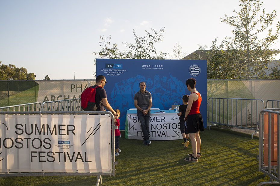 Τρεις ενήλικες και δύο παιδιά συζητούν στον χώρο του SUMMER NOSTOS FESTIVAL STAVROS NIARCHOS FOUNDATION