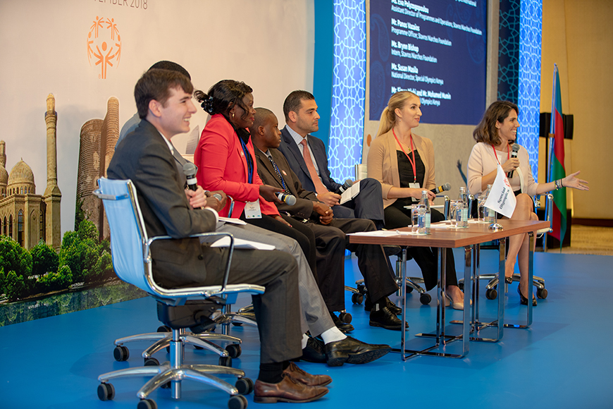 Members of the Stavros Niarchos Foundation and the Youth Leadership Forum with young people sitting and talking on stage
