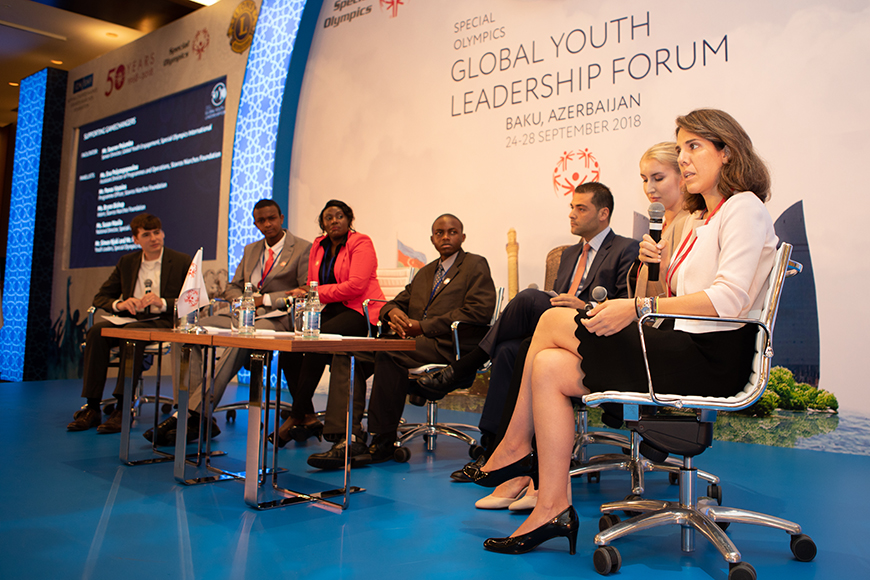 Members of the Stavros Niarchos Foundation and the Youth Leadership Forum with young people sitting and talking on stage at the Global Leadership Youth Forum