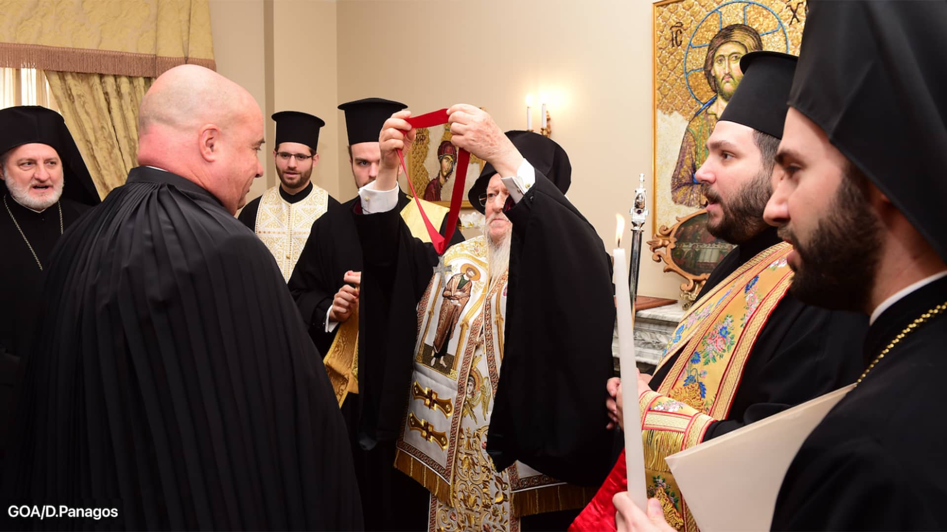 Ecumenical Patriarch Bartholomew places a cross around co-president of SNF Andreas Dracopoulos' neck honoring him as Archon Grand Orator