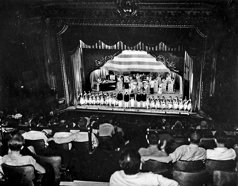 An old photograph depicting a crowd watching a performance at the Baltimore Parkway Theatre