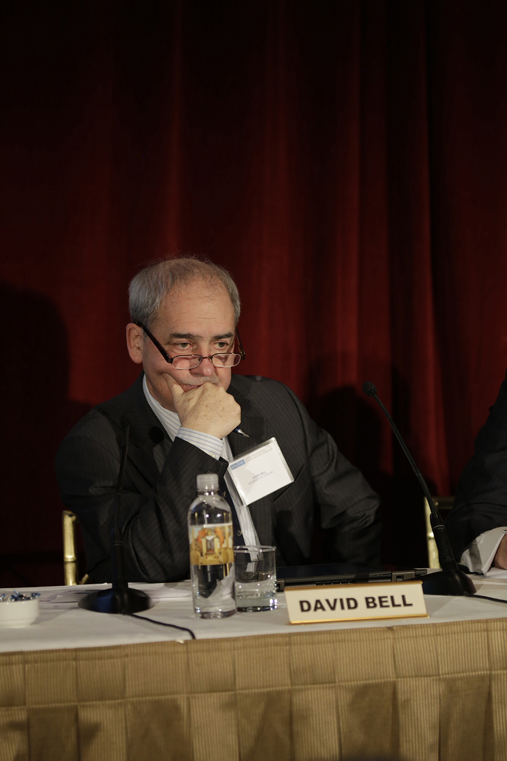 Ένας άνδρας που ανήκει στους εκπροσώπους της διάσκεψης κάθεται στο τραπέζι και δείχνει σκεπτικός.