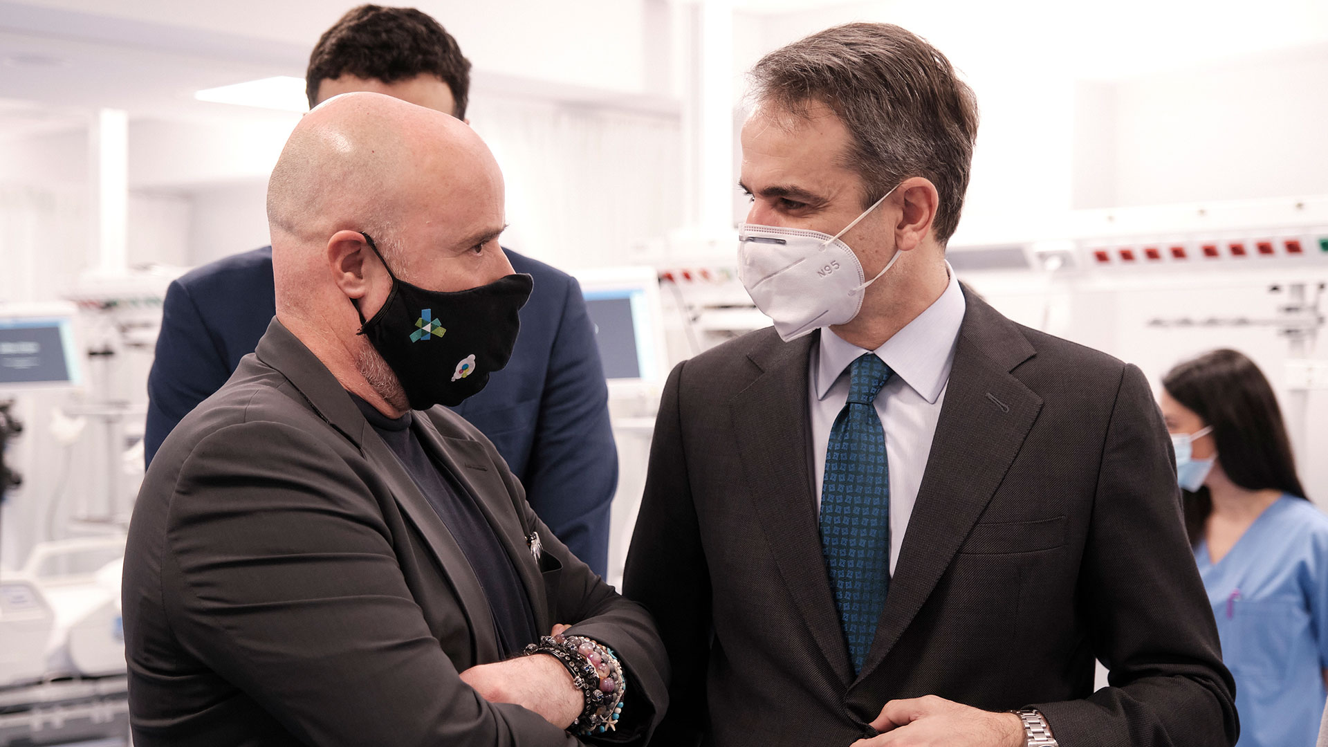 Ο Αντρέας Δρακόπουλος, Πρόεδρος του Ιδρύματος Σταύρος Νιάρχος, μιλά με τον Κυριάκο Μητσοτάκη, Πρωθυπουργό της χώρας φορώντας και οι δυο μάσκα